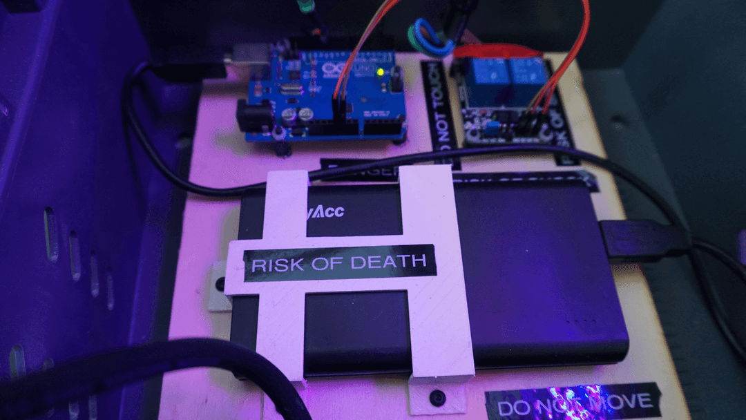 Arduino electronic in a plastic box, labeled risk of death