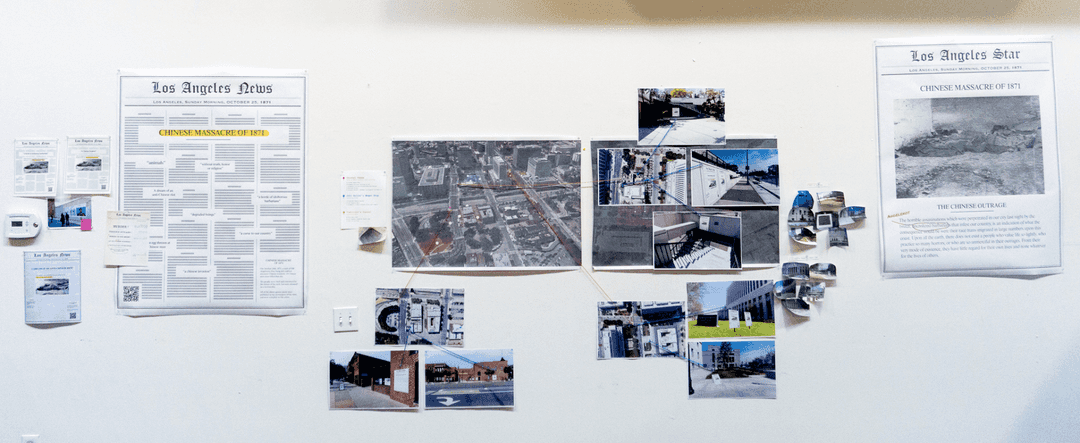 Printed mockups, designs, and photos pinned to a wall