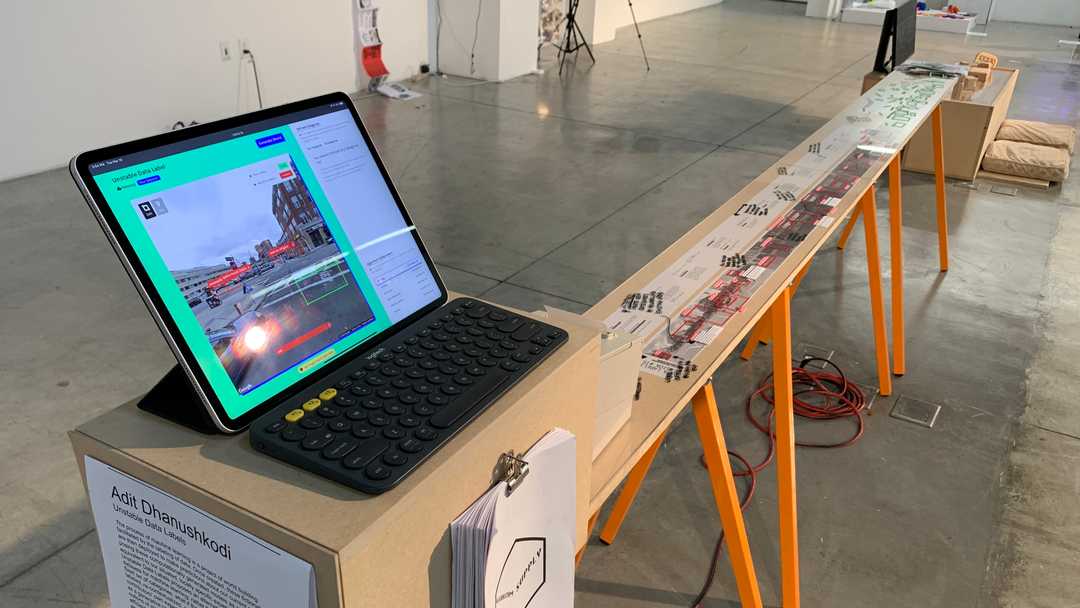 A long display table with an iPad sitting at the front