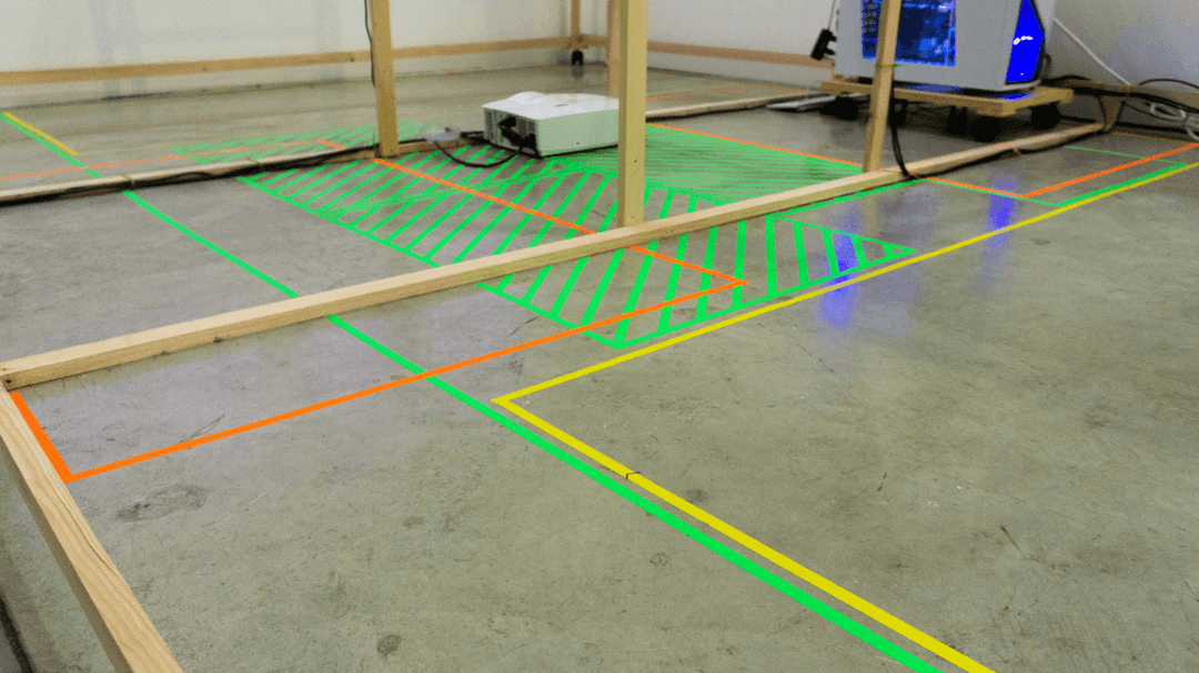 Concrete floor covered in neon tape denoting different zones