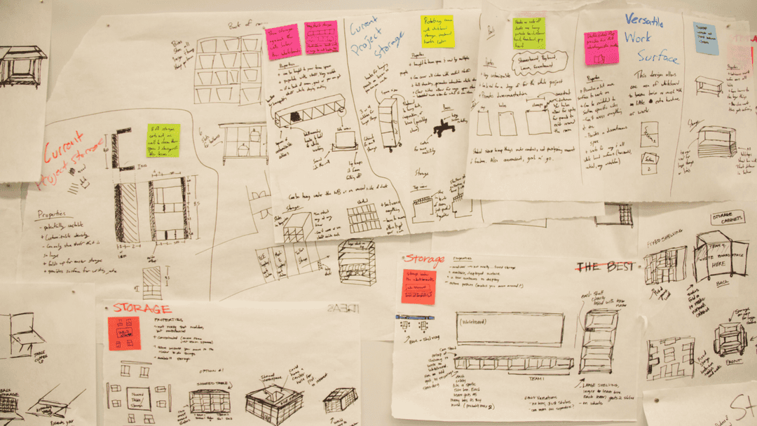 Sketches of furniture and room layouts on butcher paper and tacked to the wall